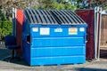 Closed waste management blue garbage container dumpster used for commercial and residential garbage.m