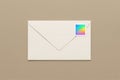 Closed white envelope with holographic postage stamp on beige background, minimal mail and communication concept, top view Royalty Free Stock Photo