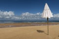 White umbrella projecting its shade on the white sand beach of Ponta do Muta, Barra Grande, Camamu Bay, Brazil, South America