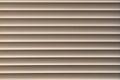 Closed window blinds illuminated by the sun, background texture Royalty Free Stock Photo