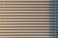 Closed window blinds illuminated by the sun, background texture Royalty Free Stock Photo