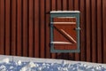 Closed window blinds of red wooden cabin in snow, Z-shaped texture Royalty Free Stock Photo