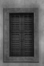 Closed window with old wood shutters, monochrome background Royalty Free Stock Photo