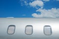 Closed windows on gray metallic corporate jet