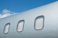 Closed windows on gray metallic corporate jet