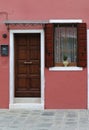 Brown door on pink facade