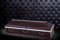 Closed wooden brown sarcophagus  on gray luxury background. casket, coffin on royal background. Royalty Free Stock Photo