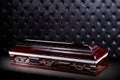 Closed wooden dark brown coffin on gray luxury background. casket, sarcophagus on royal background. Royalty Free Stock Photo