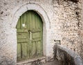 Closed wooden door and stone wall in Berat, Albania Royalty Free Stock Photo