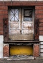 Closed Wooden Doors with Peeling Painting on Abandoned Factory Building