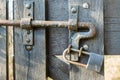 Closed wooden gate with old rusty padlock Royalty Free Stock Photo