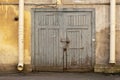 closed wooden gate in the wall of an old house Royalty Free Stock Photo
