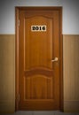 Closed wooden office door with Number 2016.