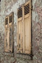 a closed wooden shutter on the wall of a house Royalty Free Stock Photo