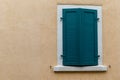 a closed wooden shutter on the wall of a house Royalty Free Stock Photo