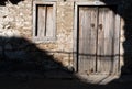 Closed wooden vintage damaged door. Traditional cyprus doors and brick wall. Deserted places