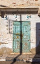 Closed abandoned wooden weathered door and shabby old grunge wall Royalty Free Stock Photo