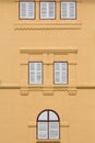 Closed wooden windows on orange building. Royalty Free Stock Photo