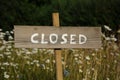 Closed written at a wooden sign