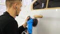 Closely shown as a professional worker polishes the transport car body using a polishing tool machine. Concept from: Auto serv