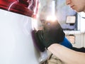 Closely shown as a professional worker polishes the transport car body using a polishing tool machine. Concept from: Auto serv