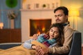 Closely sleeping Indian couples on sofa during winter at home by covering blanket - concept of relaxation, romantic