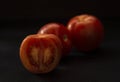 Closep of fresh juicy tomatoes on a dark background