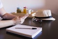 Closep up view of young woman hands working on smart phone with cup of coffee, notebook and breakfast besides. Work space. Royalty Free Stock Photo