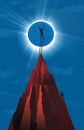 A closer look. A man climbs to a mountain peak to get a closer look a the solar eclipse