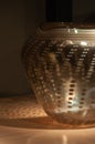 Closer shot of golden glass vase with concentric patterns in the dark at the Seattle Center, Seattle, USA