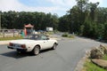 Closer up Classic little italian sports car on downhill road