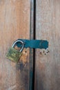 A metal security padlock for the protection of a wooden door Royalty Free Stock Photo