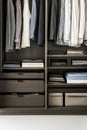 A closet with many clothes and a few books Royalty Free Stock Photo