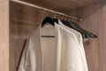 Closet white bathrobes hanging on rack Royalty Free Stock Photo