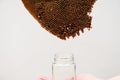 Closeup abandoned beehive with glass jar below isolated on the white background