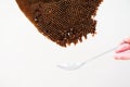 Closeup abandoned beehive with the spoon below isolated on the white background