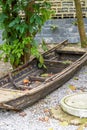 Closeup of an abandoned wooden boat near the lake in the park Royalty Free Stock Photo