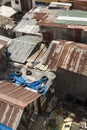 Closeup above view of rusty sheet metal roofing of slum houses of a squatter area in Manila.