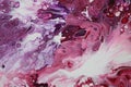 Closeup on an abstract acrylic pour painting of a clashing tempest, done in shades of red, purple, and white. Royalty Free Stock Photo