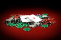 Closeup of the ace of hearts and ace of clubs on poker chips on a red table