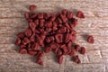 Achiote seeds closeup on balsa wood