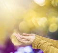 Closeup action of woman hold out hand to wait for good things on abstract blurred colorful light spot bokeh textured background