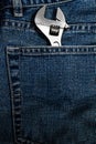 Closeup of an adjustable wrench in jean pocket Royalty Free Stock Photo
