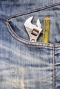 Closeup of an adjustable wrench in a jean pocket Royalty Free Stock Photo