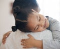 Closeup adorable little girl smiling and hugging her single father inside at home. Cute mixed race child enjoying Royalty Free Stock Photo