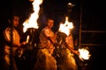 Closeup of adult people with fiery torches at night in India