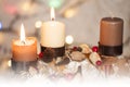 Closeup of Advent wreath with two burning candle and Christmas lights in background Royalty Free Stock Photo