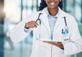 Closeup african american woman doctor using a digital tablet and interacting with copyspace in the hospital. Modern Royalty Free Stock Photo