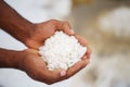 Closeup of african hands holding salt from the QuiÃÂ§ama Salt Flats against blurred background