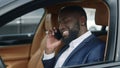 Closeup african man using phone at car. African man talking mobile at vehicle Royalty Free Stock Photo